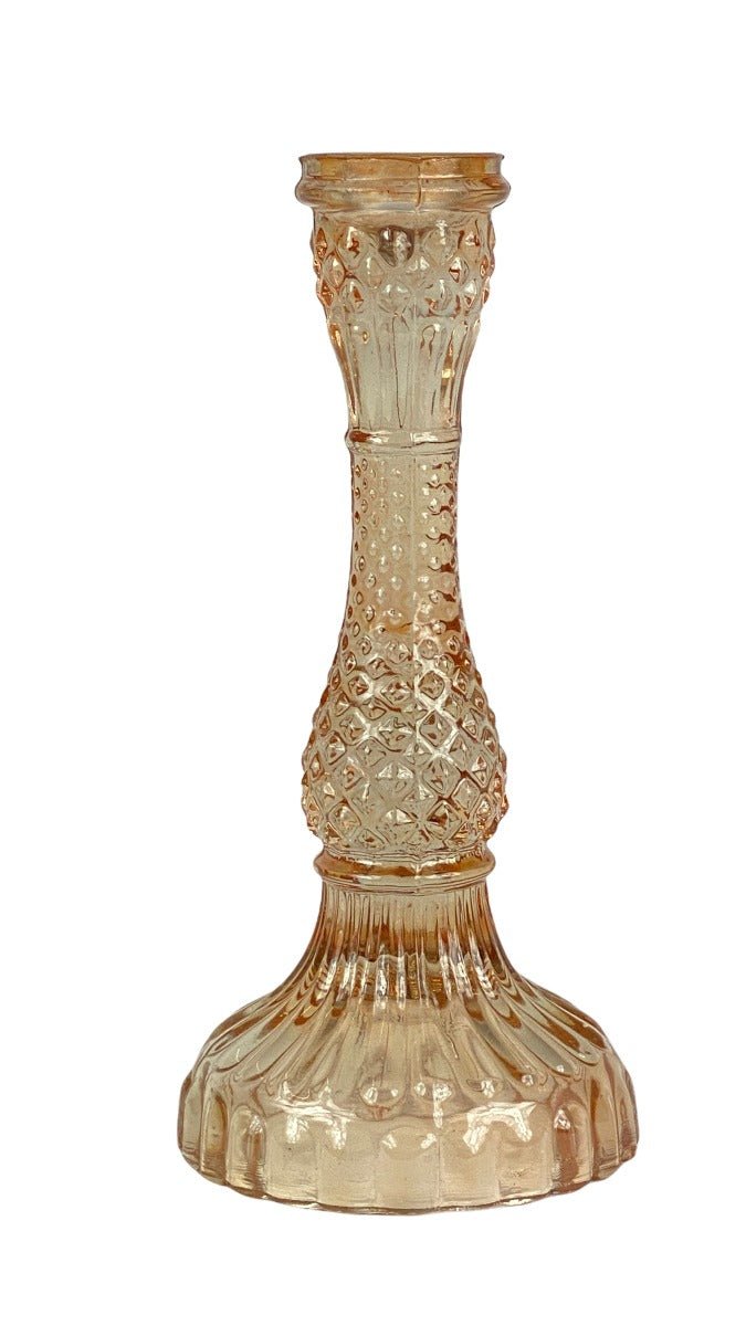 Decorative glass candle holder with intricate patterns on a white background