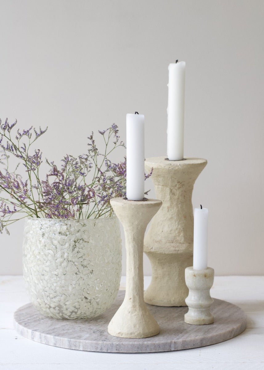 Handcrafted paper mâché candle holder with sculptural form and natural texture. Made from recycled materials, each piece is unique.