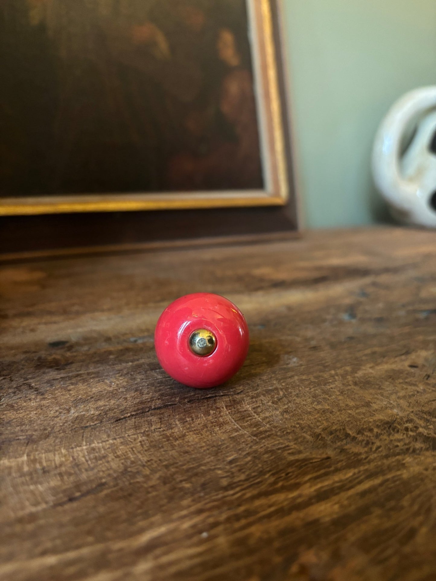 Red ball with a central hole on a wooden surface