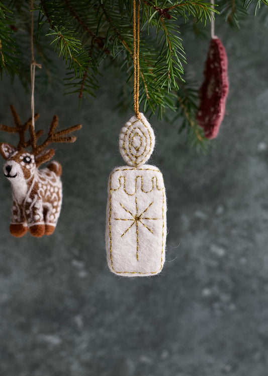 Decorative Christmas ornament with geometric design hanging from a tree.