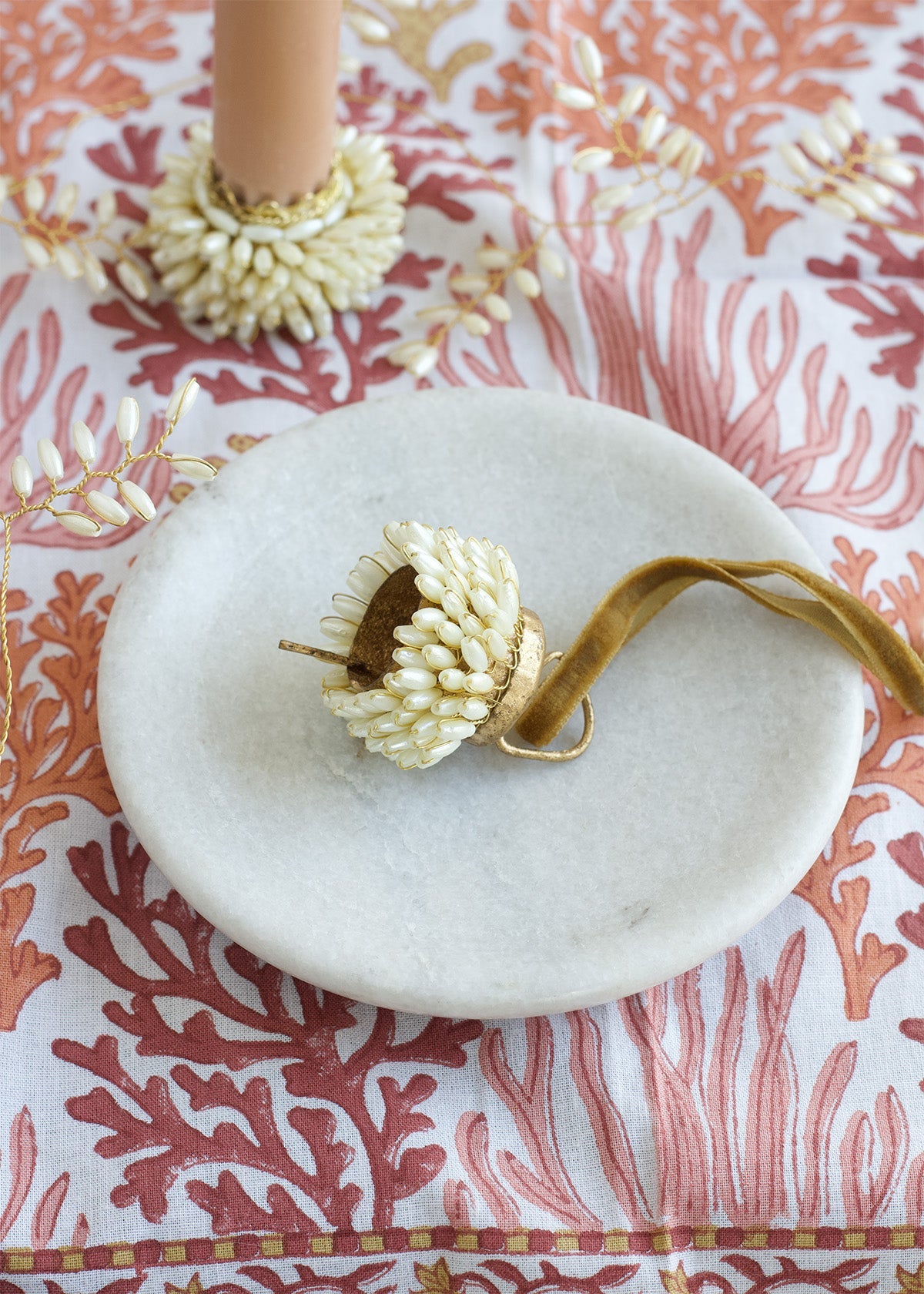 Decorative item on a marble plate with a coral-patterned background