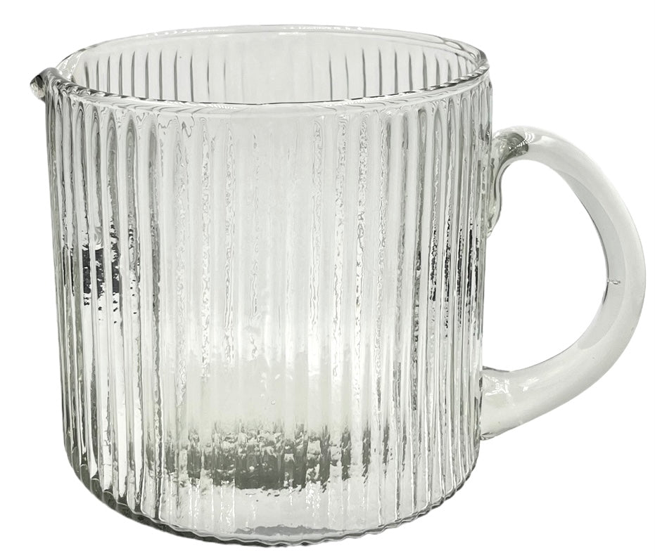 Clear ribbed glass jug with a wide cylindrical body, rounded handle, and a small spout.