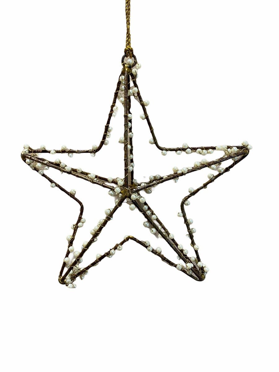 Rustic star ornament made of brown twigs and adorned with small white beads, suspended by a gold string.