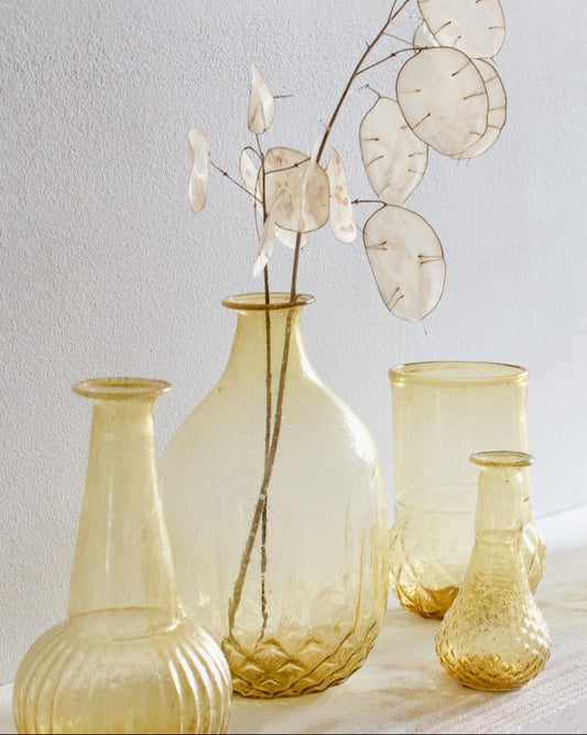 Set of glass vases with textured surfaces on a light background