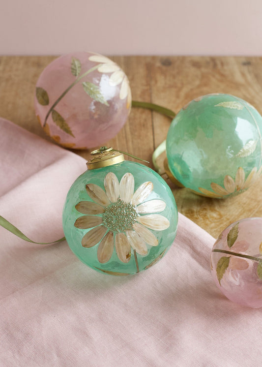 Decorative string lights with floral designs on a wooden surface.