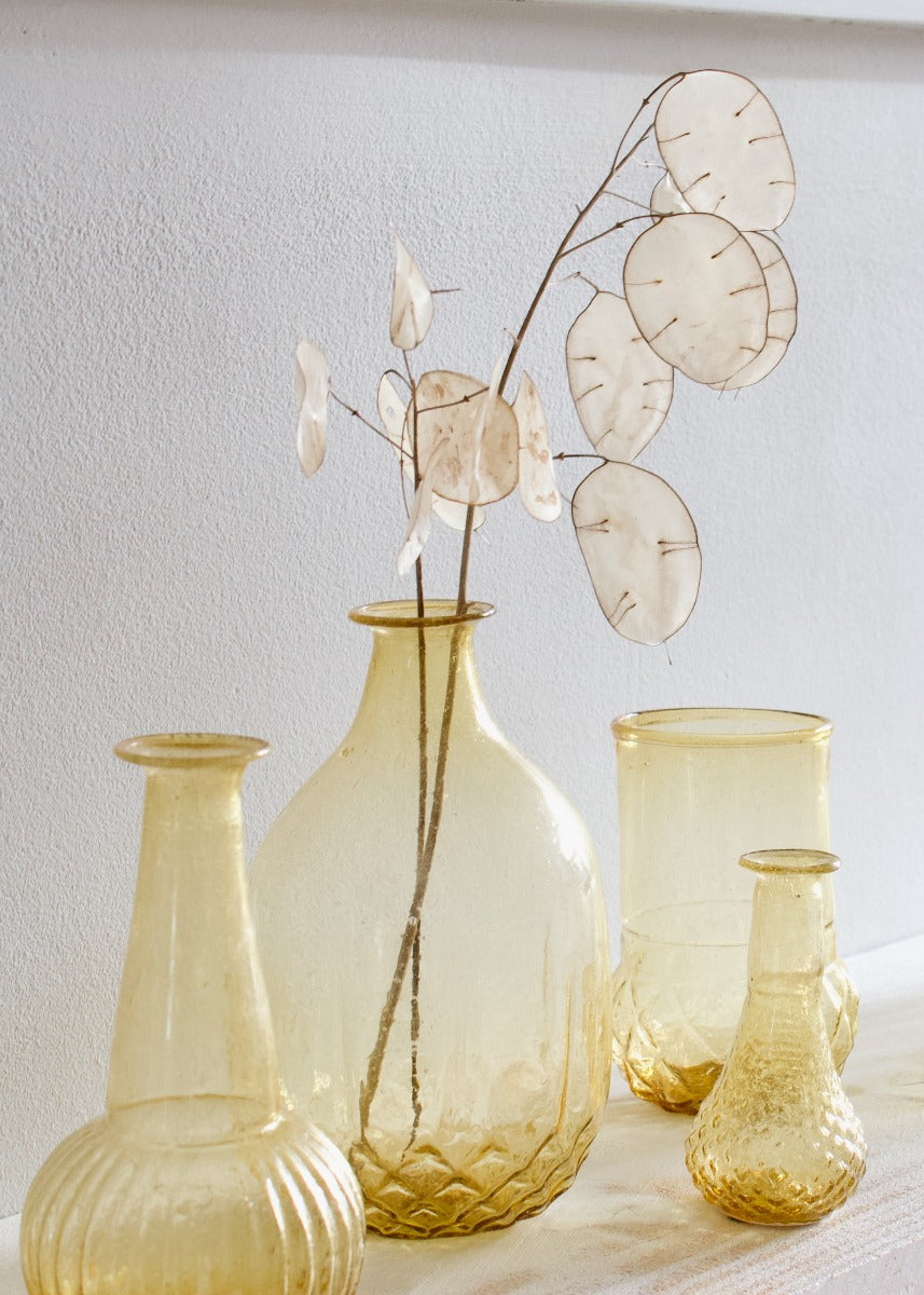 Set of glass vases with textured surfaces on a light background