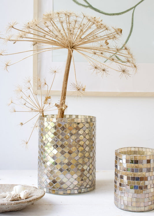 Medium-sized mosaic vase with golden and mother-of-pearl tiles, styled with a dried allium flower on a white table.