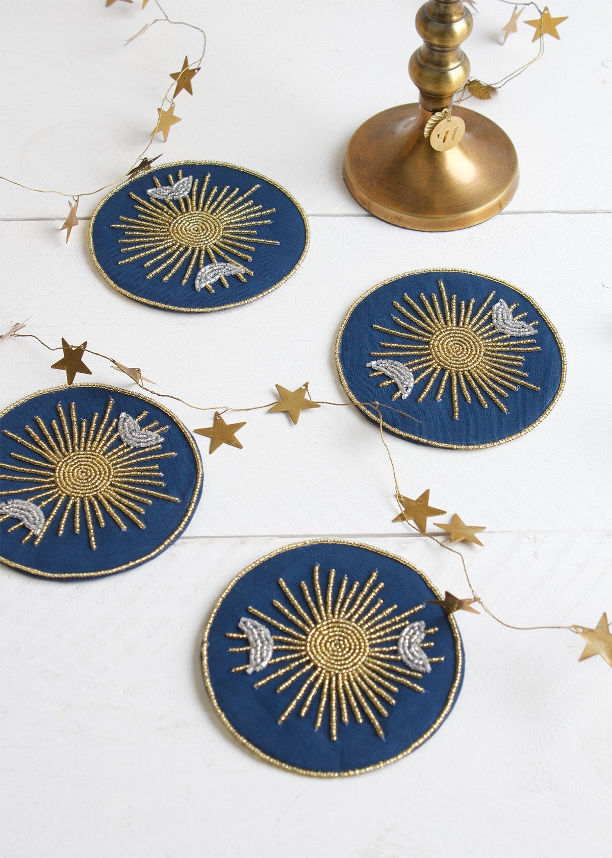 Decorative blue and gold coasters with star designs on a white surface.