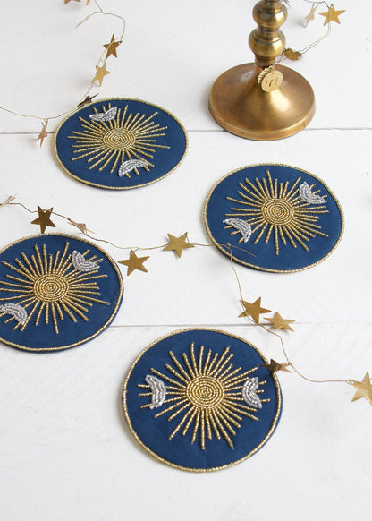 Decorative blue and gold coasters with star designs on a white surface.