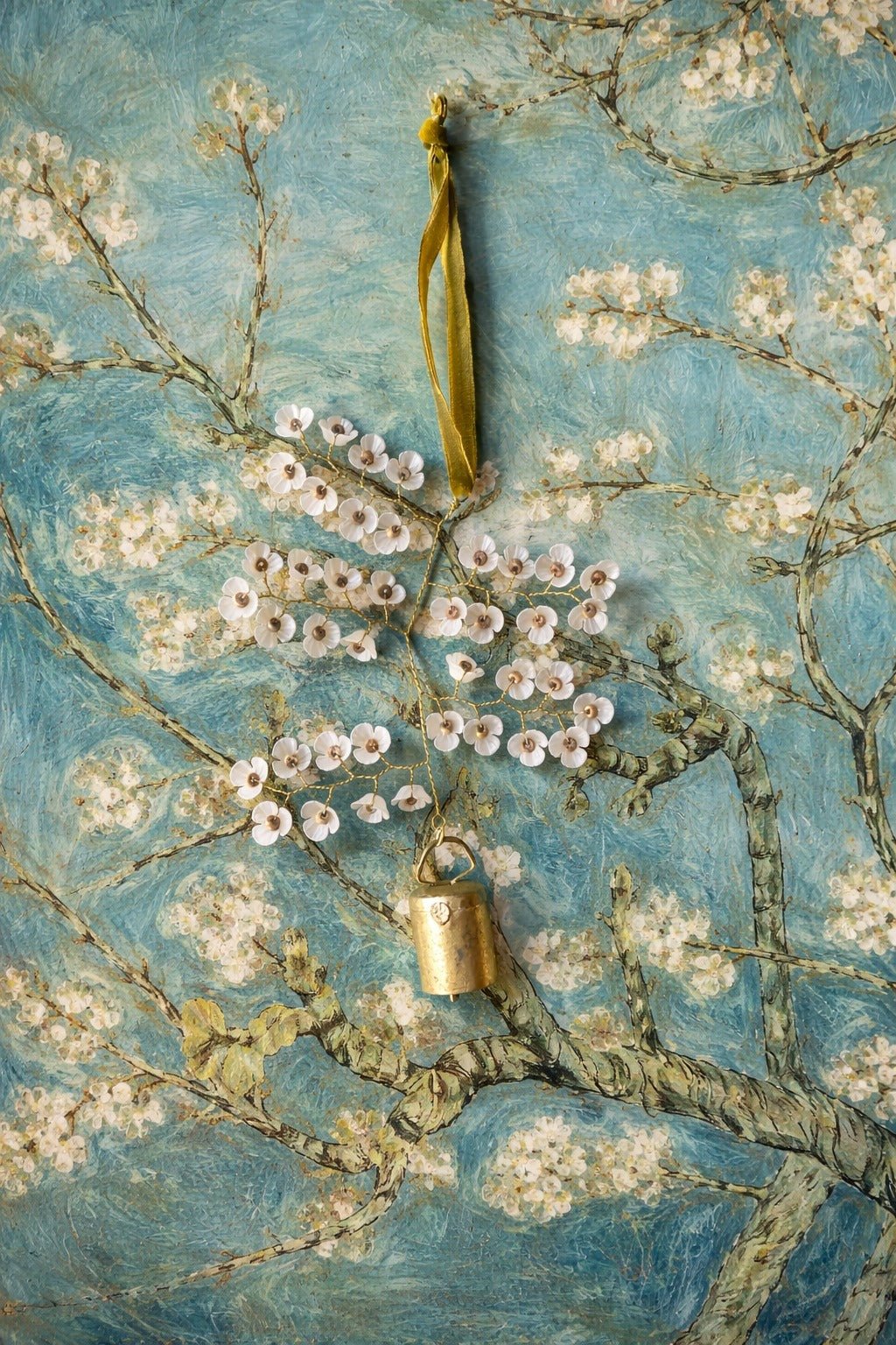 Floral branch with a lock and ribbon against a textured blue background
