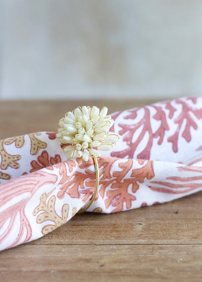 Floral-patterned headband with a decorative flower on a wooden surface