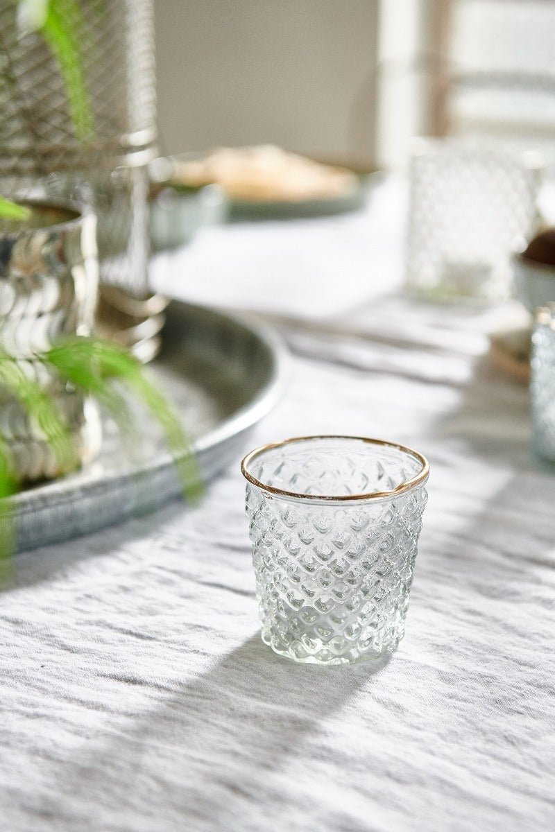 Handmade clear glass tealight holder with gold rim. Adds a warm elegant glow to dinner tables, mantels or festive styling.