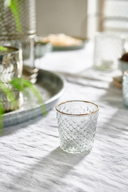 Handmade clear glass tealight holder with gold rim. Adds a warm elegant glow to dinner tables, mantels or festive styling.