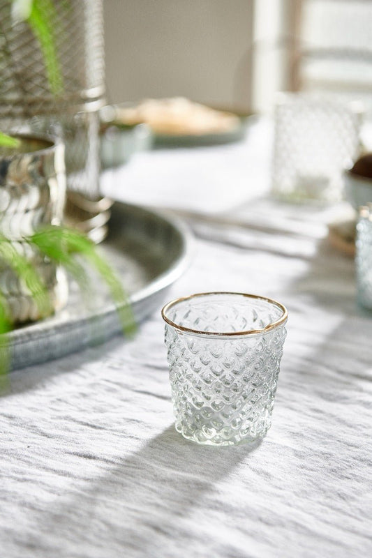 Handmade clear glass tealight holder with gold rim. Adds a warm elegant glow to dinner tables, mantels or festive styling.