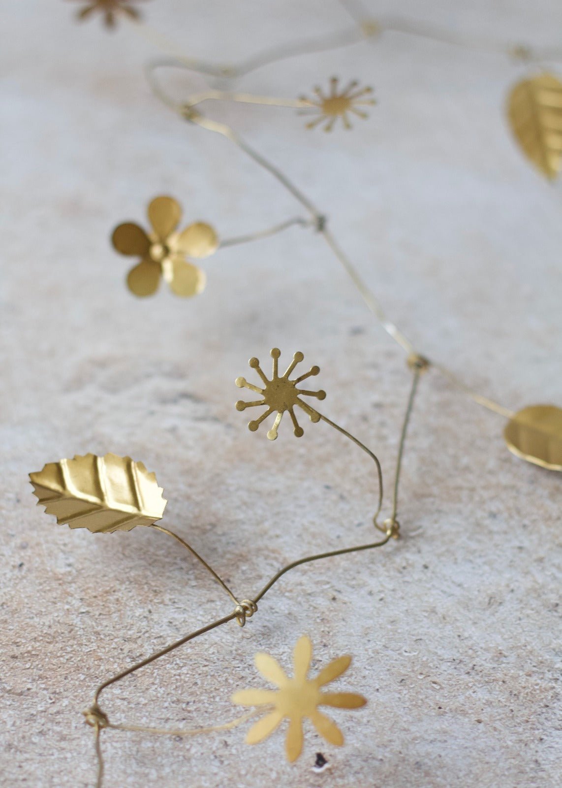 Gold floral and leaf-shaped decorations on a textured surface