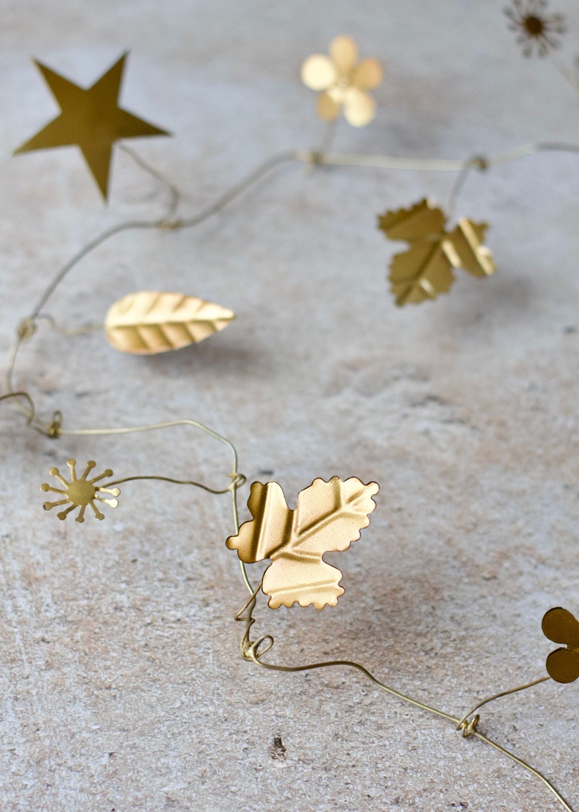 Gold leaf and star-shaped decorations on a textured surface