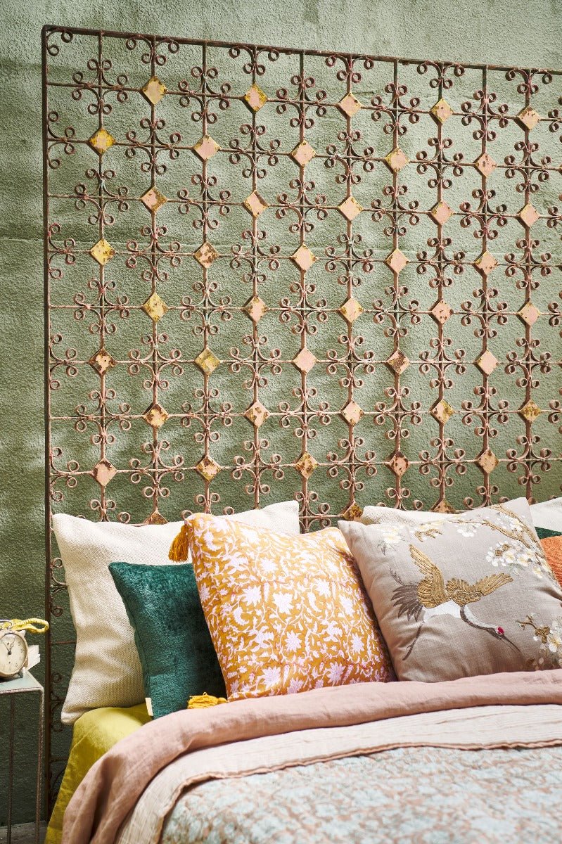 Set of different color handmade cushion s on a bed features a beautiful design crafted from cotton greige with embroidery