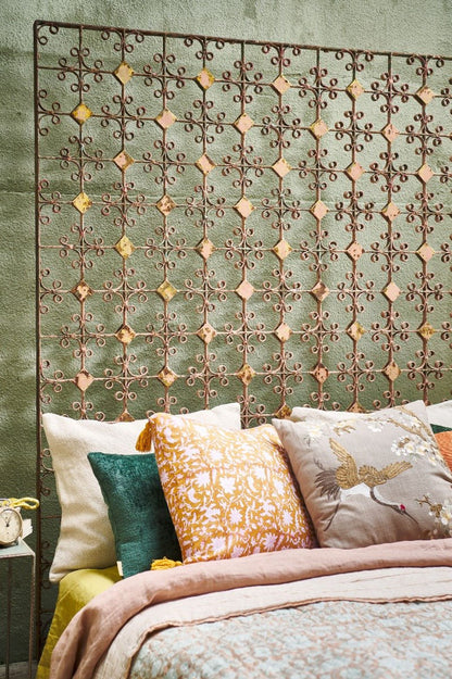 Set of different color handmade cushion s on a bed features a beautiful design crafted from cotton greige with embroidery