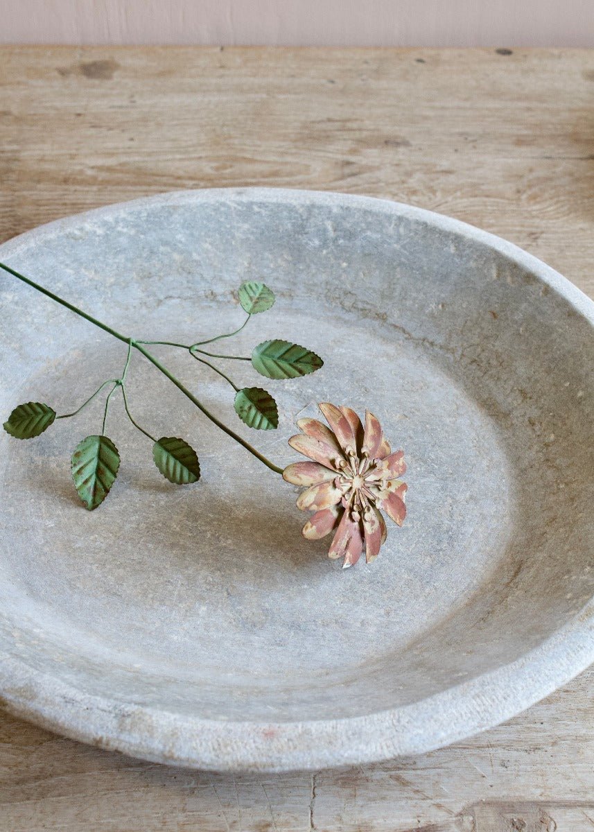 Handmade dusty rose metal flower with green leaves on a wire stem