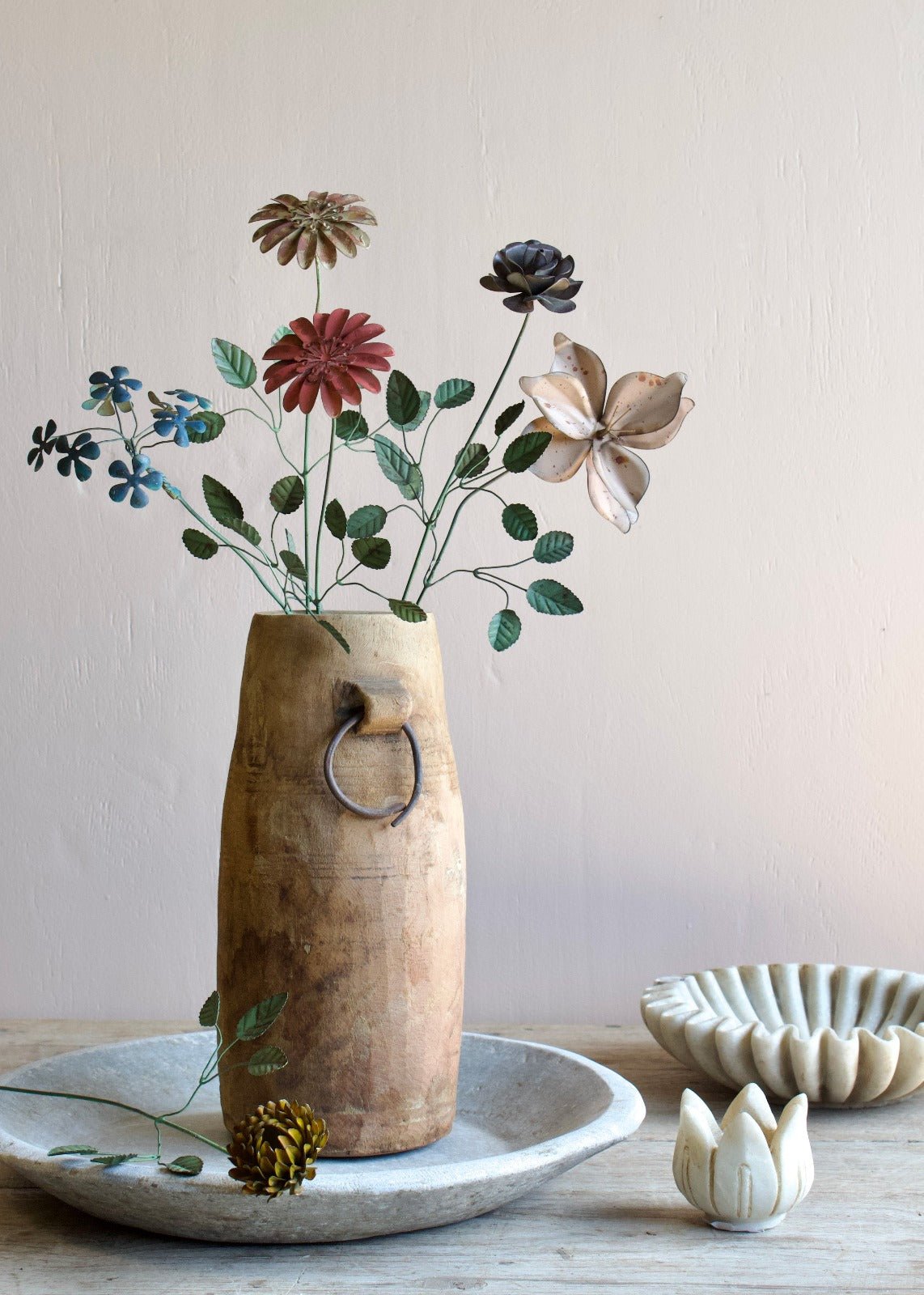 Wooden vase with flowers on a neutral background