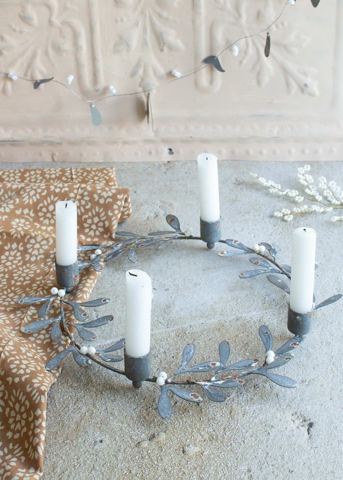 Decorative wreath with candles on a neutral background