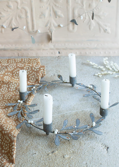 Decorative wreath with candles on a neutral background