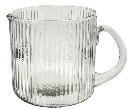 Clear ribbed glass jug with a wide cylindrical body, rounded handle, and a small spout.