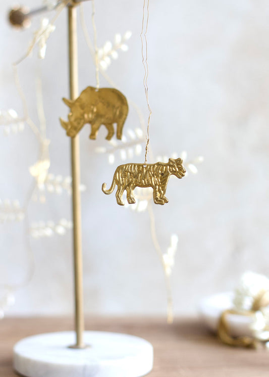Decorative stand with gold animal figurines against a blurred background with lights