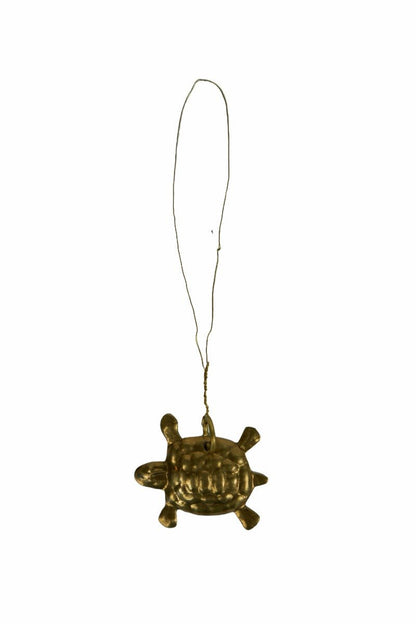 Brass turtle ornament with hanging wire on white background