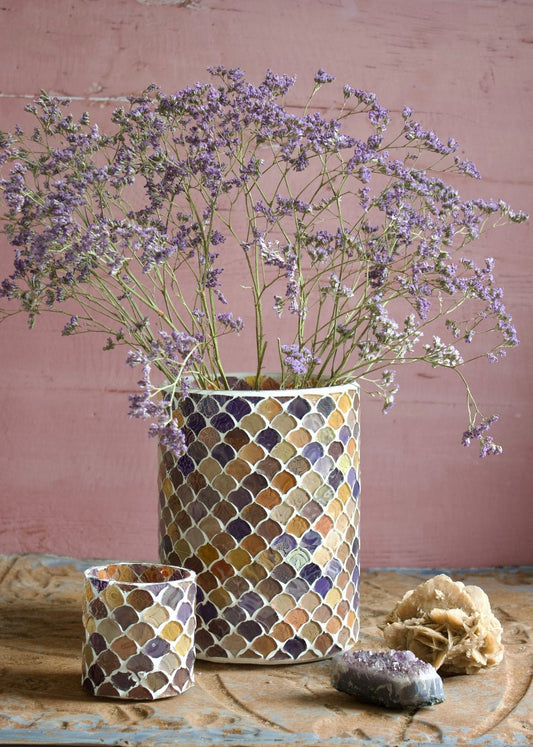 Handmade mosaic vases in warm terracotta and purple tones, featuring a scale-like pattern, styled with dried flowers and crystals.
